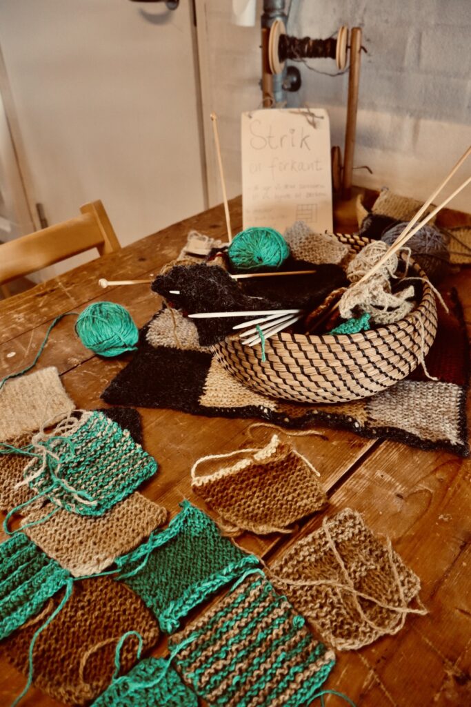 Korb mit Garn, Stricknadeln, gestrickten Quadraten